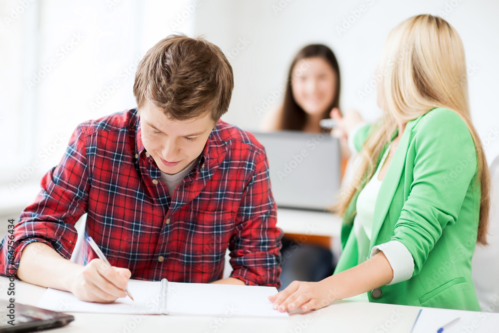 students writing something at school students writing something at school