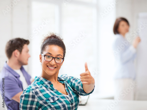 african student girl showing thumbs up