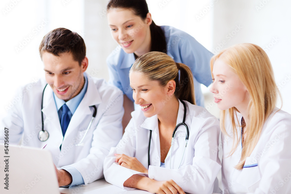 group of doctors looking at tablet pc group of doctors looking at tablet pc