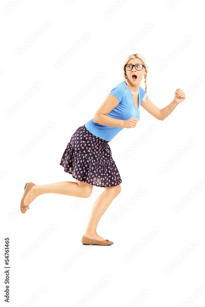 Full length portrait of a scared woman running away Full length portrait of a scared woman running away