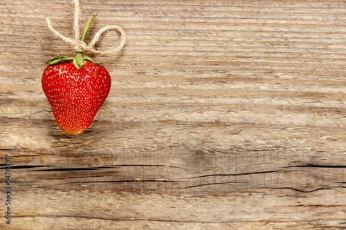 Fresh ripe strawberries on jute background. Copy space.