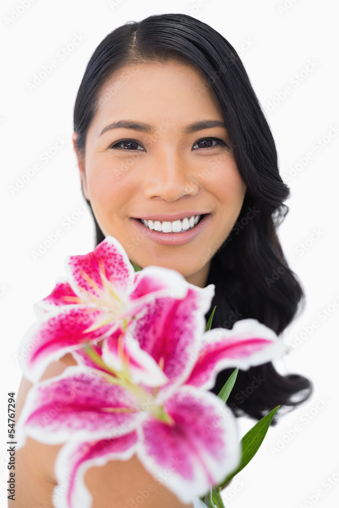 Happy natural brown haired model posing with lily Happy natural brown haired model posing with lily