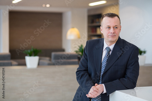 A businessman in suit standing near the reception