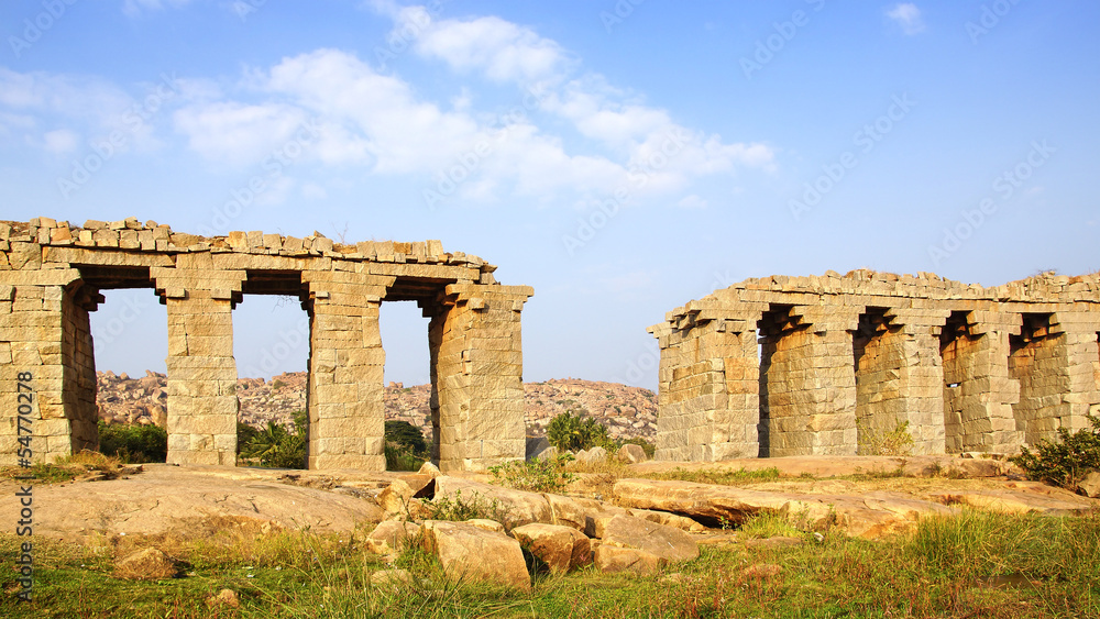 Landscape with ruins of ancient bridge. Hampi, India.