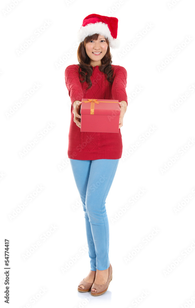 Full body Christmas woman holding gift wearing Santa hat. Full body Christmas woman holding gift wearing Santa hat.