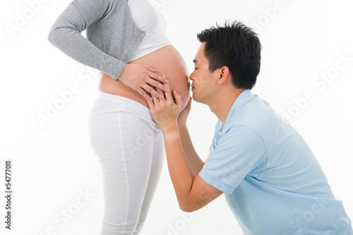 chinese husband listening to his wife's stomach