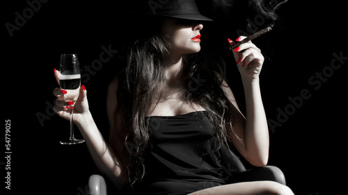young woman with black hat, cigarillo and red nails