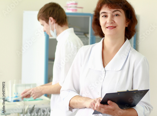 A medical doctors standing in dentist office