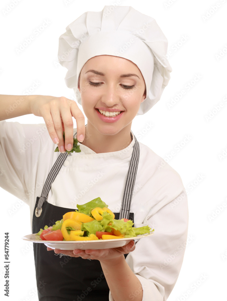 Portrait of a young cook in uniform preparing meal Portrait of a young cook in uniform preparing meal