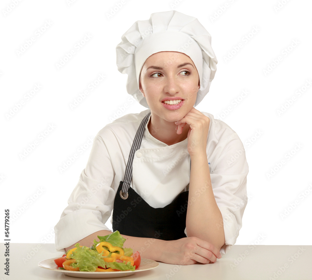 Pretty cook chief sitting at the table with salad Pretty cook chief sitting at the table with salad