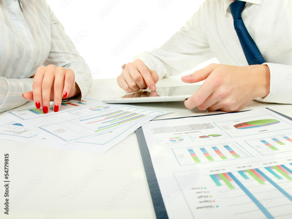 two business partners discussing documents lying two business partners discussing documents lying