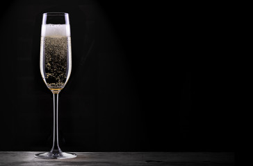 glass of champagne isolated on black background