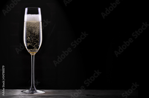 glass of champagne isolated on black background photo