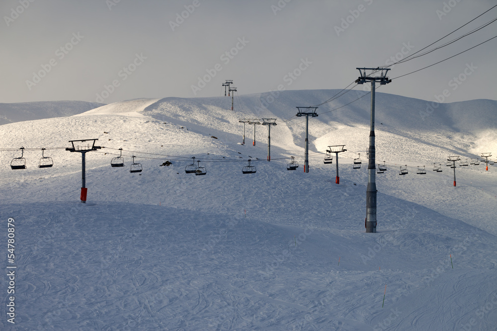 Ski slope with chair-lift in evening