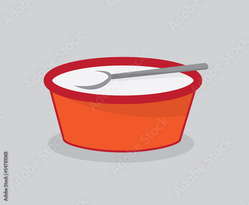 Bowl of milk for cereal with spoon