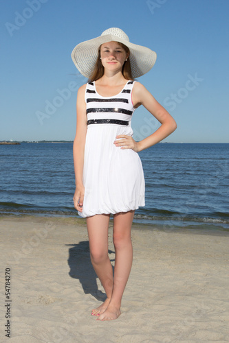 attractive woman in white dress on sandy beach