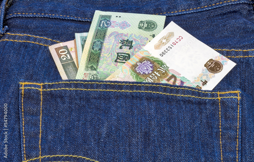 Chinese mone in the back pocket of a pair of blue jeans Chinese mone in the back pocket of a pair of blue jeans