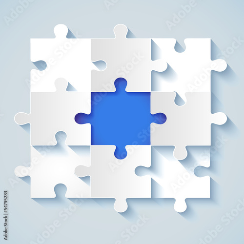 Paper puzzle with a blue the middle for business concepts