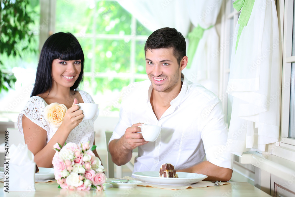 Beautiful young romantic couple at cafe