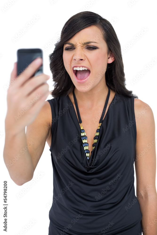 Angry elegant brown haired model screaming to her phone Angry elegant brown haired model screaming to her phone