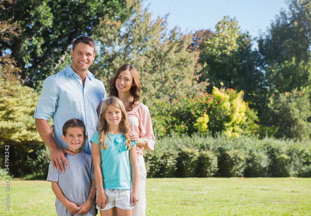 Fototapeta premium Family standing in a park