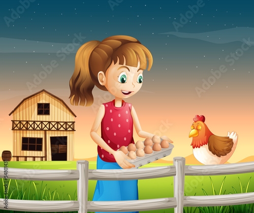 A woman holding an eggtray with eggs near the fence