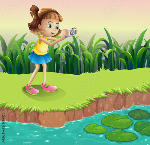 A girl taking photos at the pond