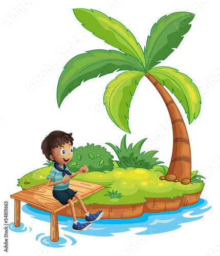 A boy with a scarf sitting above the wooden bridge in the island