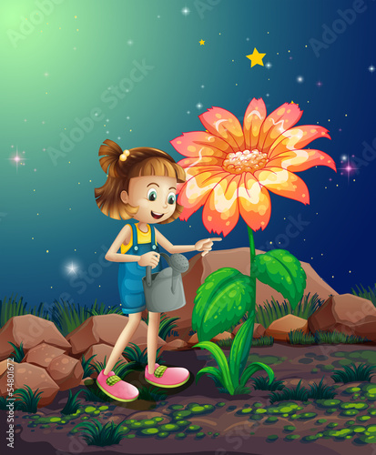A small girl watering the giant plant