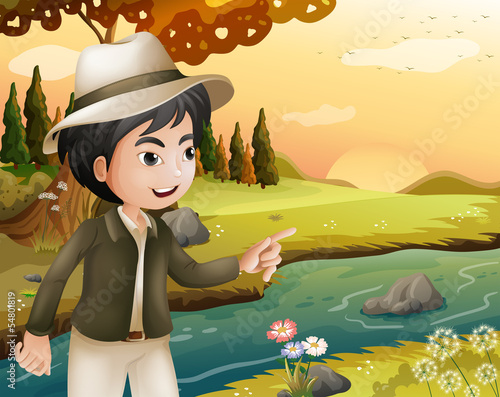 A man with a hat at the riverbank