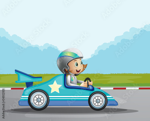 A happy girl in her blue racing car