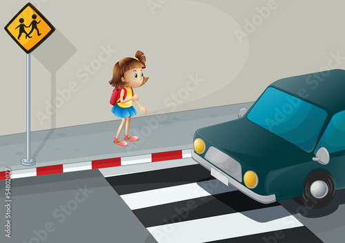 A little girl near the pedestrian lane