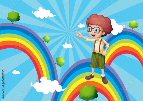 A boy pointing a tree