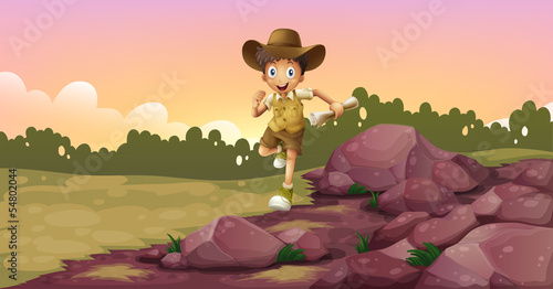 A boy running holding a map
