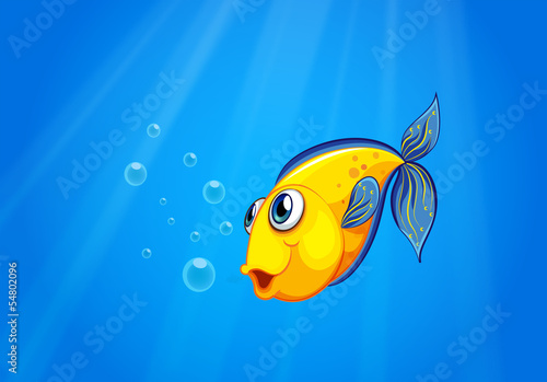 A yellow fish swimming under the sea