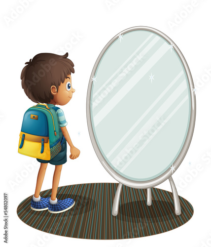 A boy facing the mirror