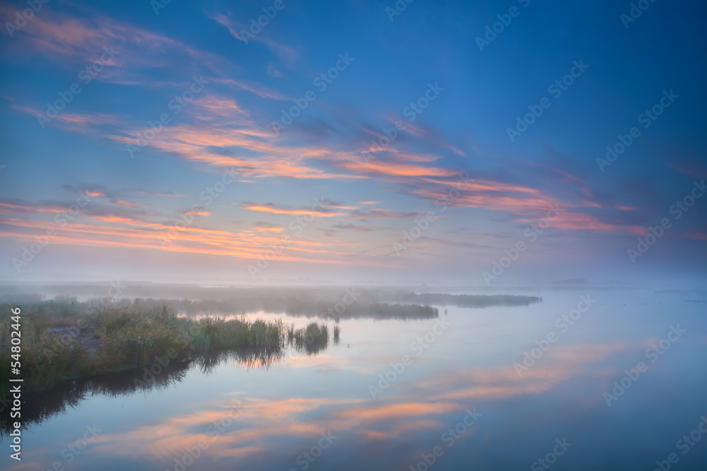 sky reflected in lake at misty morning sky reflected in lake at misty morning