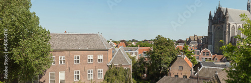 Panoramic photo of roofs and church of dutch city Leiden in summ