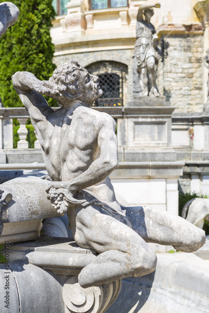 Allegoric stone statue in Peles castle garden, Sinaia, Romania