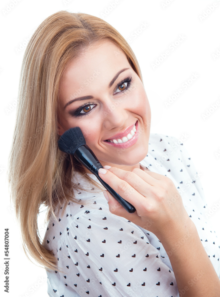 Woman applying cosmetics to her face Woman applying cosmetics to her face