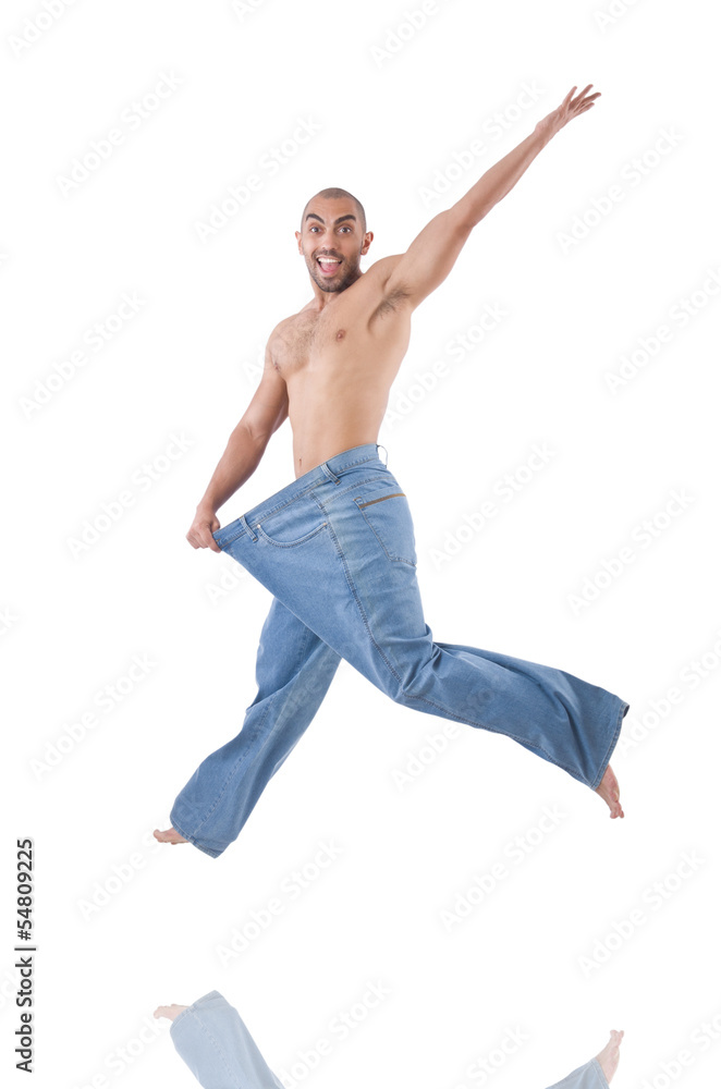 Man in dieting concept with oversized jeans Man in dieting concept with oversized jeans