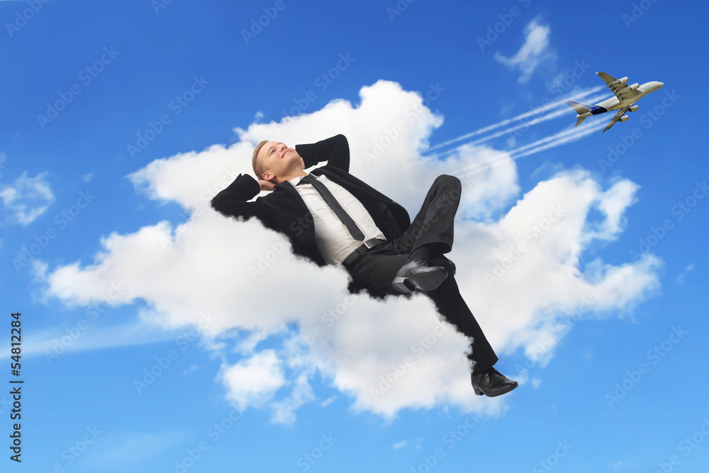 Businessman sleeping in a cloud Businessman sleeping in a cloud