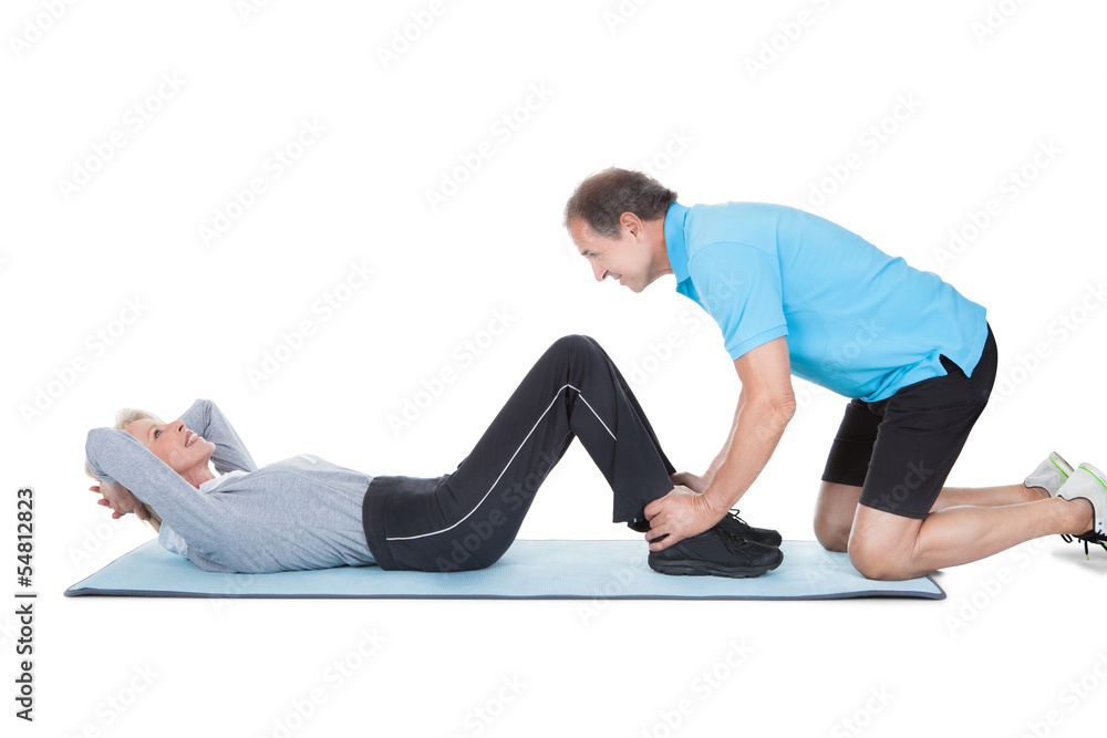 Fitness Instructor Help Woman Doing Exercise Fitness Instructor Help Woman Doing Exercise