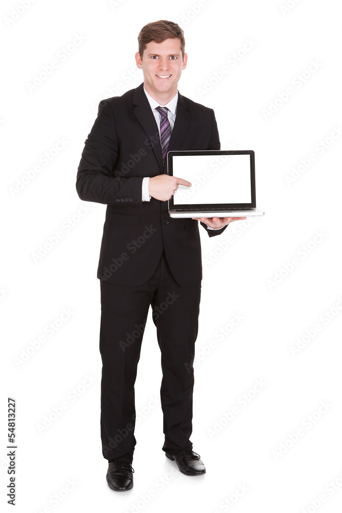 Happy businessman pointing on laptop Happy businessman pointing on laptop