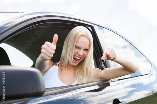 Happy Woman In A Car Showing A Key