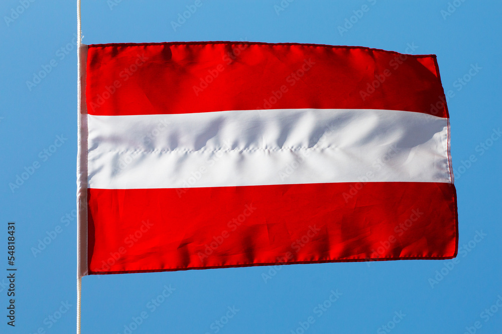 Austrian flag in the wind against a sky Austrian flag in the wind against a sky