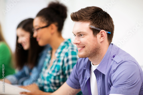 student with computer studying at school