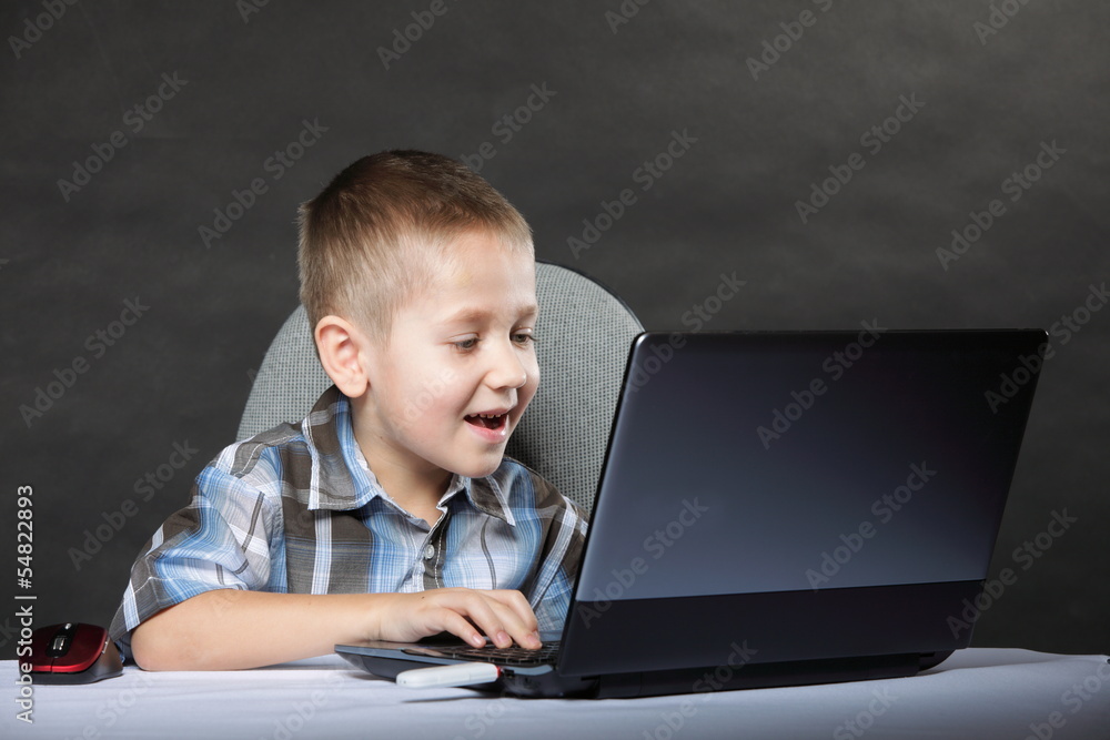 Computer addiction child with laptop notebook Computer addiction child with laptop notebook