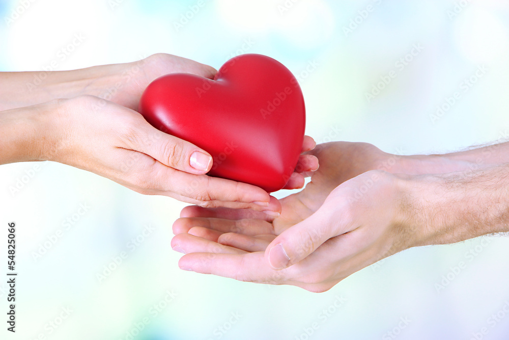 Heart in hands on light background Heart in hands on light background