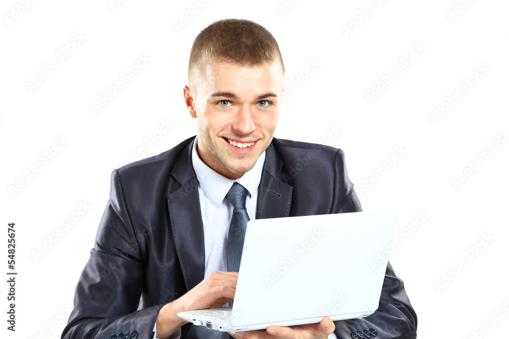 Happy young business man working on a laptop Happy young business man working on a laptop